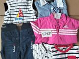 a lot of clothes that are sitting on a cardboard box