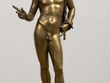 bronze statue of a male nude torsoed figure on a pedestal