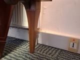 a wooden table with a black and white pattern on it
