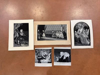several black and white photographs of people on a table