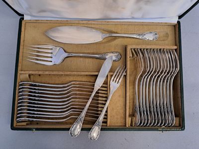 a lot of silver spoons and forks in a box