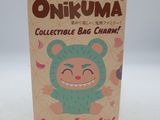 an unokuma collectible bag charm is shown on a white surface