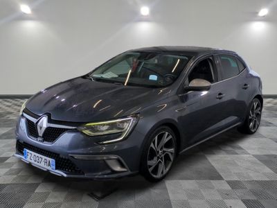a grey car is parked in a large room with a checkered floor