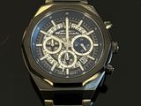 a close up of a watch on a black surface