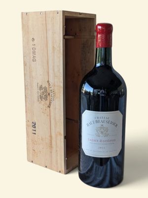 a bottle of wine sitting next to a wooden box