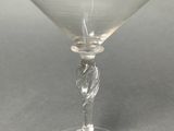 a clear glass with a bird on it on a table