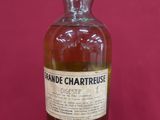 a bottle of whisky sitting on top of a red table
