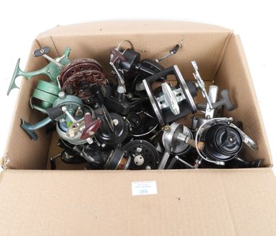 a cardboard box filled with assorted items on a white surface