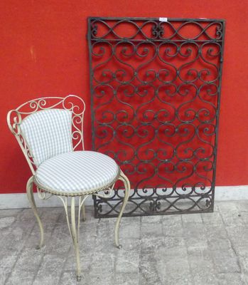 a chair and a chair that are sitting in front of a red wall