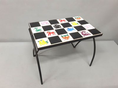 a black and white checkered table with a black and white checkerboard top