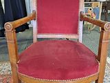 a red chair that is on a rug in a room