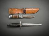 three different types of knives on a table with a leather sheath