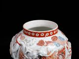 a vase with a dragon on it on a black background