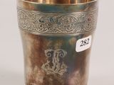 an antique silver cup with a monogram on the side