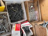 many different types of screws and nails in a box