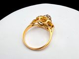 an image of a gold ring on a white surface with a black background