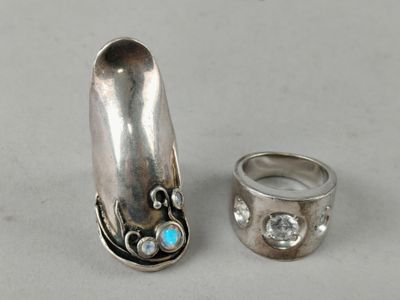 two silver rings and a silver ring with a turquoise stone
