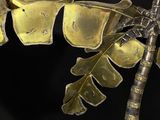 a metal sculpture of a banana tree on a black background