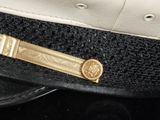 a black and white hat with a gold emblem on it