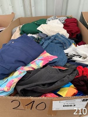 a cardboard box filled with clothes and a price tag