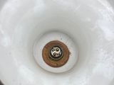 a close up of a white and gold vase with a number on it