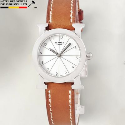 a close up of a watch on a white surface