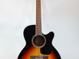 an acoustic guitar sitting on top of a stand against a white wall