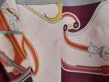 a close up of a red and white scarf with a picture of a knight on it
