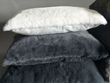 four pillows stacked on top of each other on a table