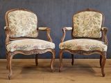 pair of louis xv style armchairs with floral upholstered upholstered cushions