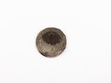 a close up of a coin on a white surface