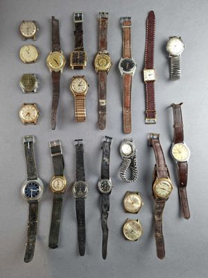 a lot of watches that are sitting on a table