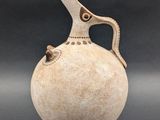 an image of a vase with a handle on it