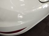 a close up of a white car with a red stripe on it