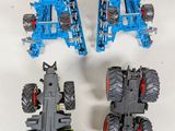 four toy tractors that are sitting on a table