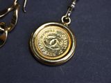 a gold coin with a chain attached to it