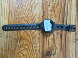 a watch that is laying on a wooden floor