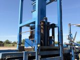 a large blue machine that is sitting on the side of the road