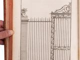 an open book with a drawing of a gate and a hand holding it