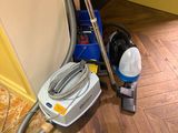 a vacuum that is sitting on the floor next to a wall