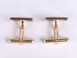pair of gold tone cufflinks on white background