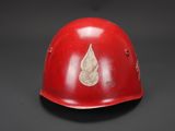 a red helmet with a leaf on it on a black background