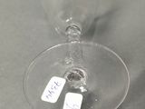 a wine glass with a tag on it sitting on a table