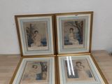 three framed pictures on a table in a room