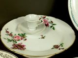 three plates and a saucer on a table