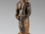 an image of a wooden statue of a woman holding a baby