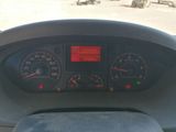 a dashboard of a vehicle with a red light on it