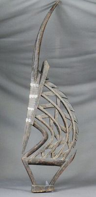 an image of a metal sculpture of a fish on a stand