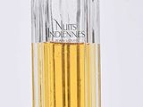 an image of a bottle of perfume sitting on a white surface