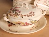 a plate with a bowl and a plate with a bird on it
